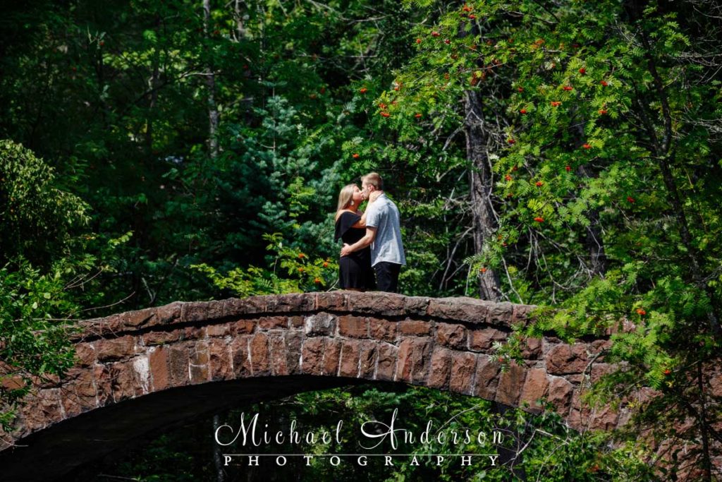 Pretty engagement photos at Glensheen Mansion taken on the stone arch bridge.