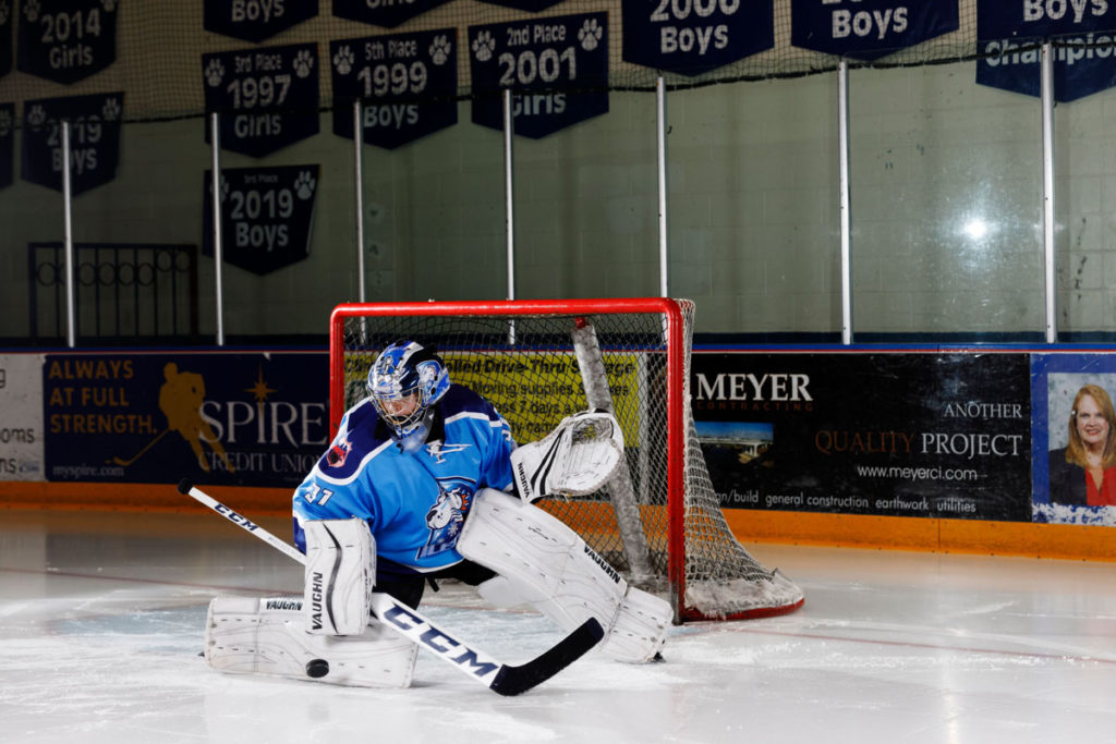 Hockey goalie action shot senior photos at Fogerty Ice Arena.
