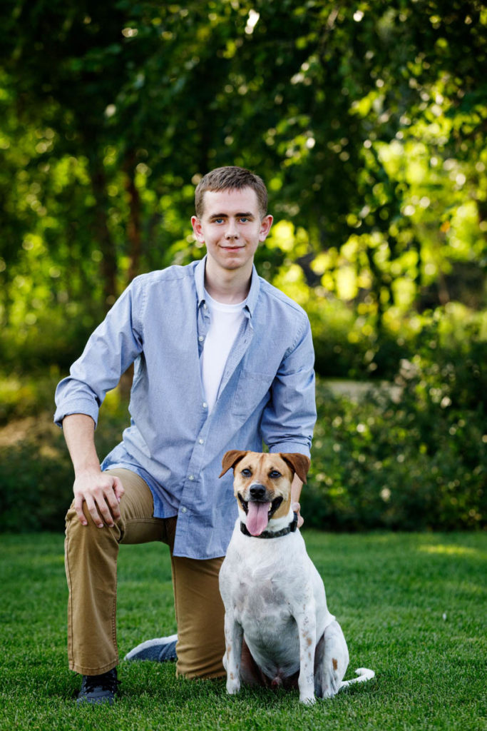 Senior portrait of a boy and his dog.