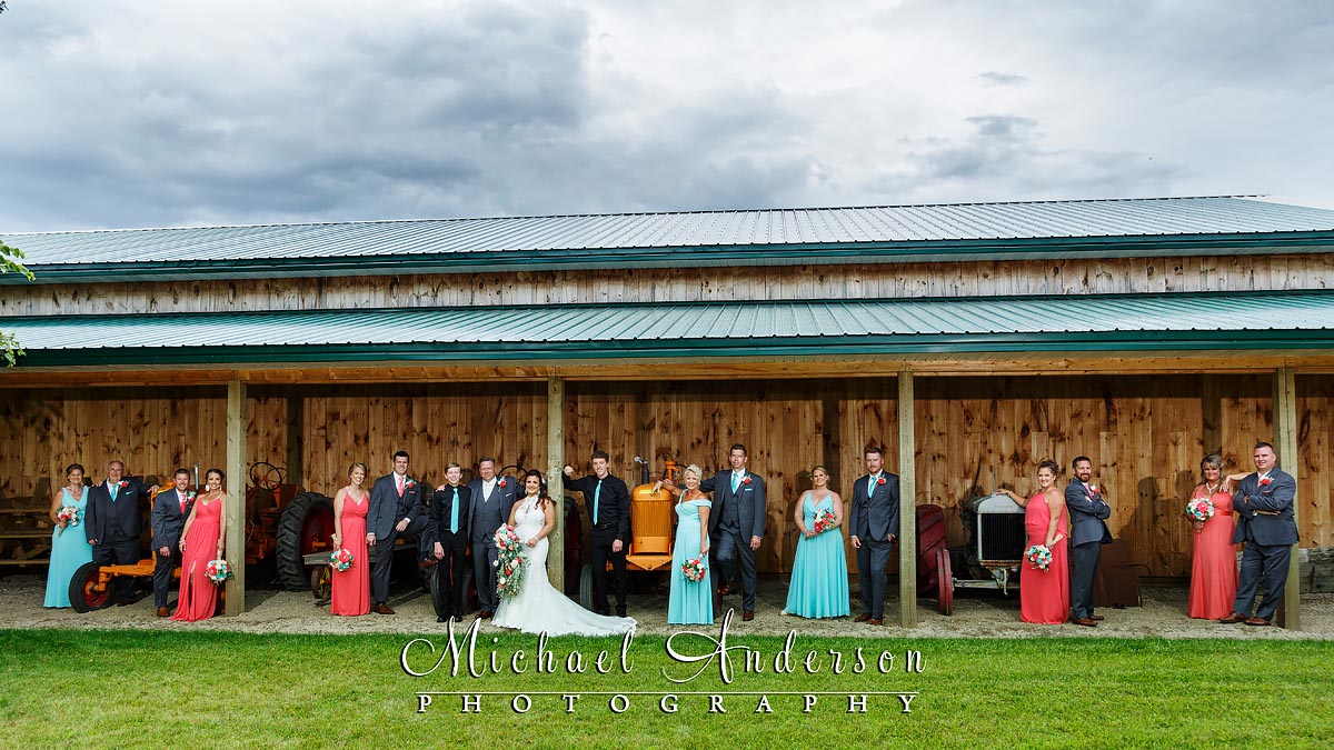 A fun wedding party photo taken at one of the many barns at Little Log House Pioneer Village.