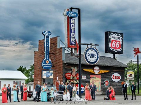 A really cool wedding party photograph at the vintage gas station at Little Log House Pioneer Village.