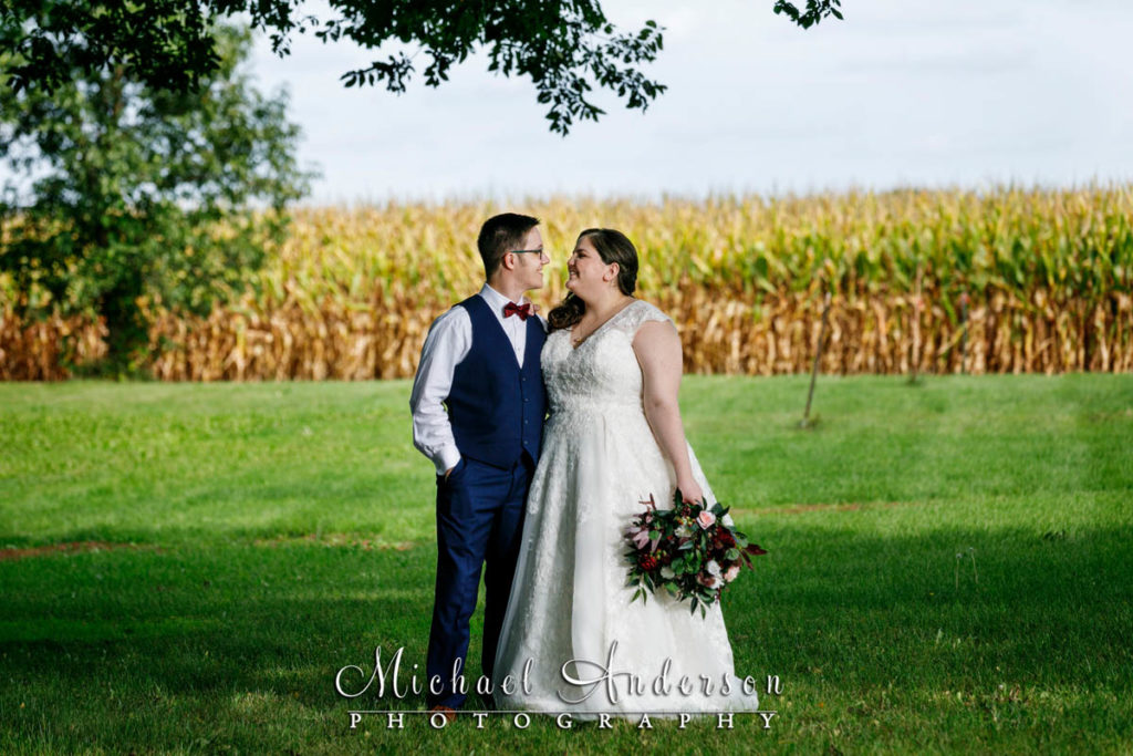 A pretty wedding photo of the bride and groom by a corn field in Lake Elmo, MN.