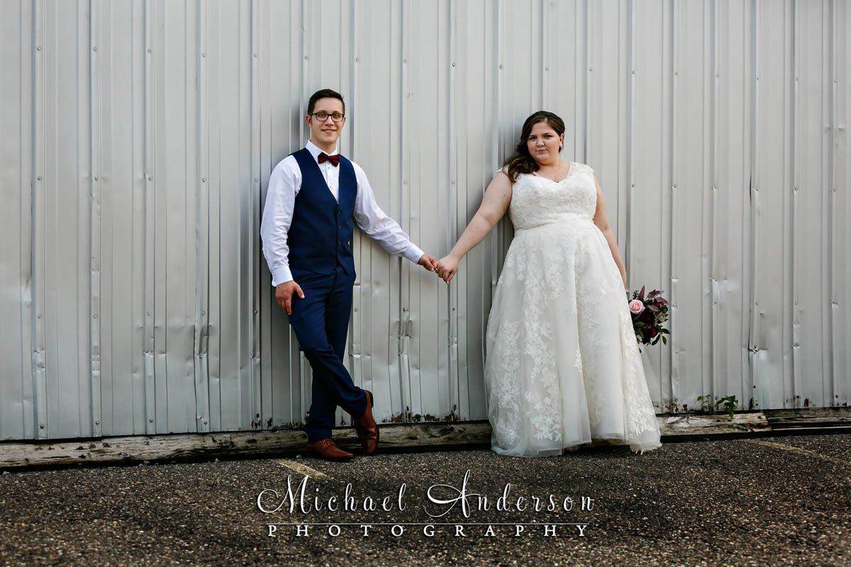Wedding photo of the bride and groom by a warehouse in Lake Elmo, MN.