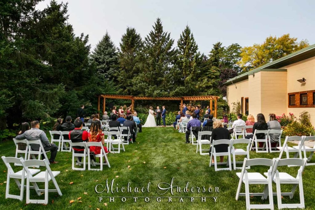 Lake Elmo Inn Event Center wedding ceremony photograph in the pretty outdoor garden area.