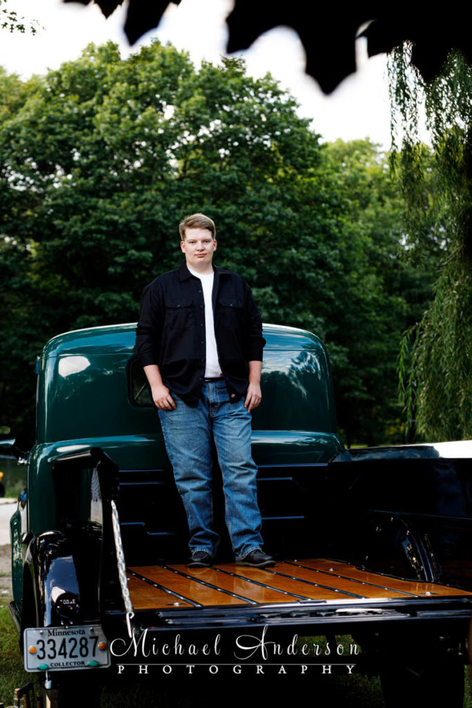 Senior photo of a boy and a mint condition 1950 Dodge B2C pick up truck.
