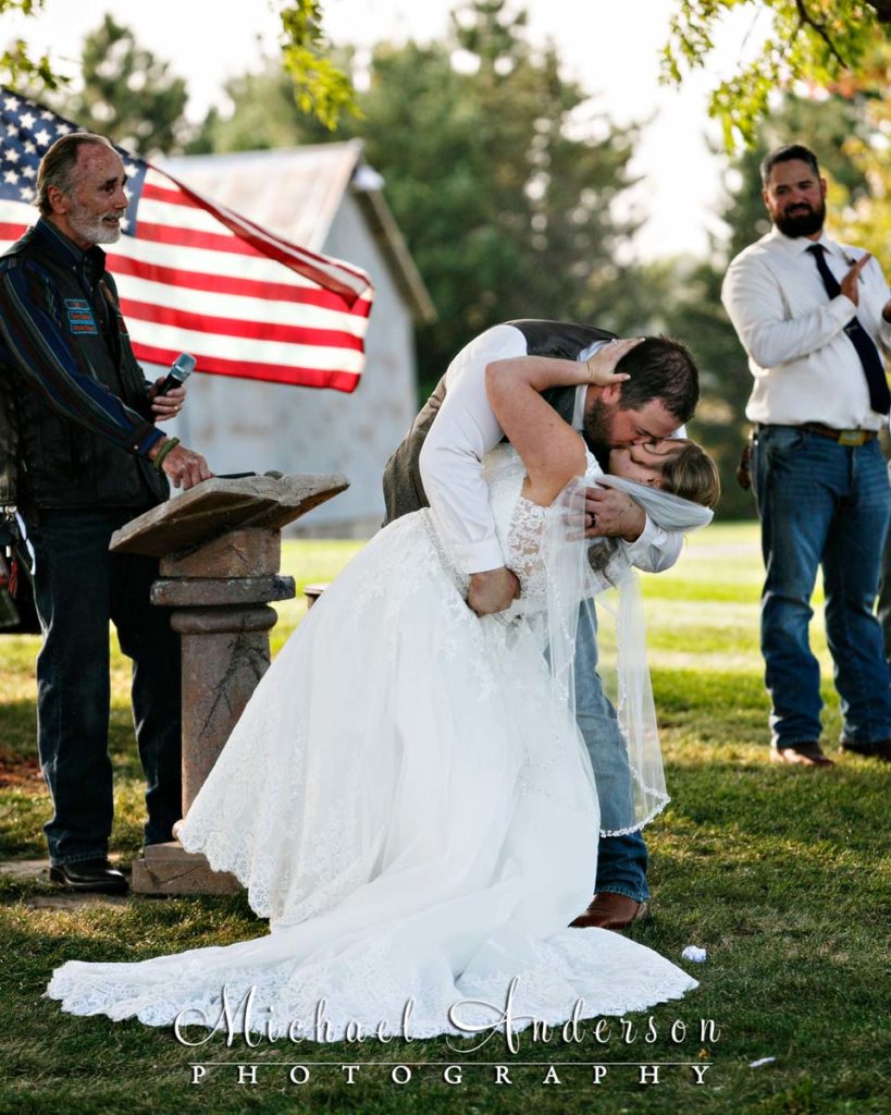 Bride and groom kissing at the end of their wedding ceremony.