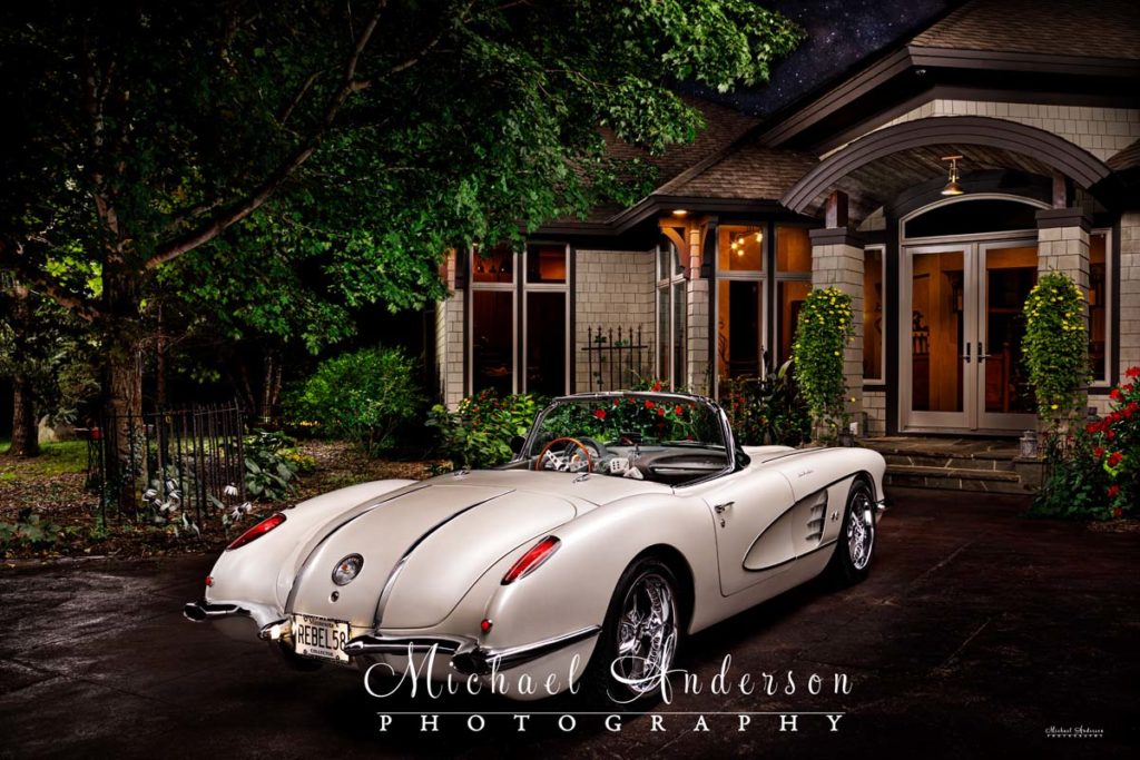 A-stunning-light-painted-photo-of-the-back-of-a-1958-C1-Corvette-in-front-of-a-beautiful-home