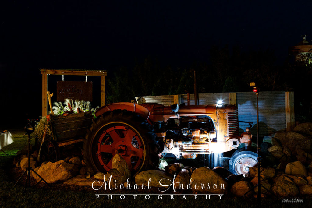 Nighttime photo of a farm tractor, converted into a water fountain.