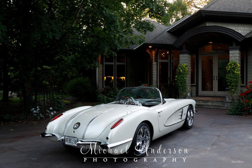 Photo of a 1958 C1 Corvette in the driveway of a beautiful home before light painting them.
