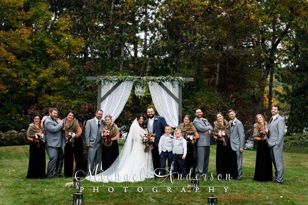 A beautiful backyard wedding photograph of the wedding party.