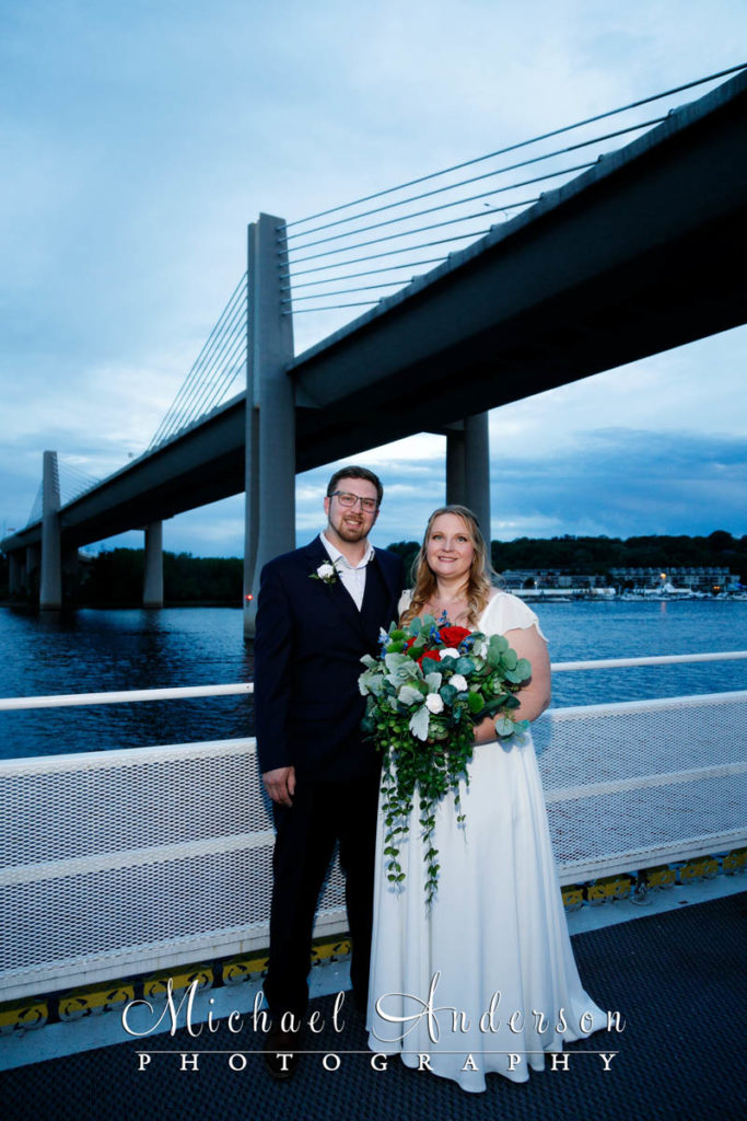Photo of the bride and groom on the third deck of the boat during their wedding reception aboard the Jubilee II.