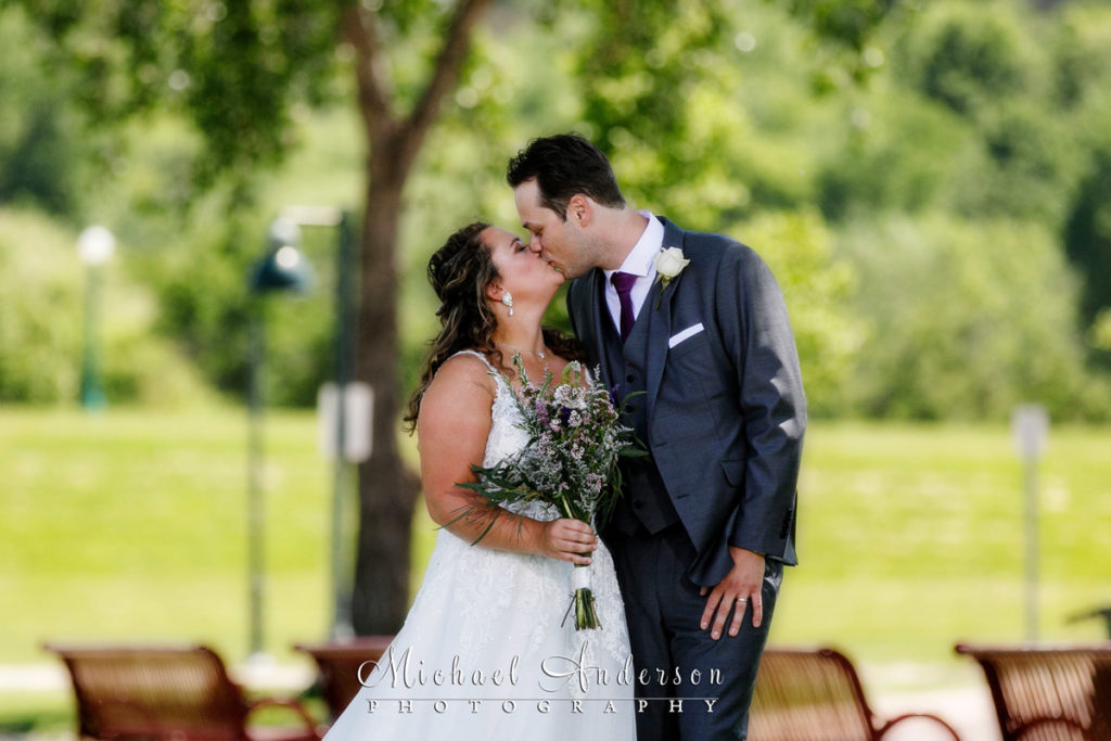 Pretty wedding photo of the bride and groom kissing on Harriet Island.