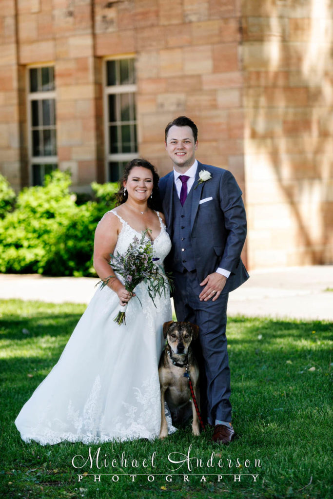 Photo of the bride and groom with their dog at Harriet Island in St. Paul, MN.