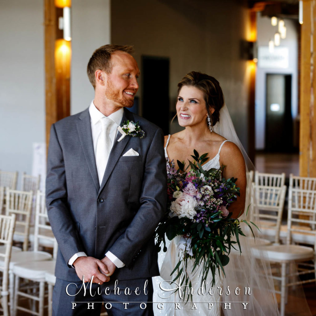 The groom's first look at his pretty bride at JX Event Venue in Stillwater, MN.