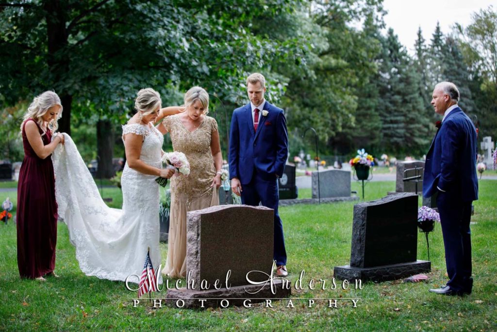 Bride and groom visiting the gravesite of her grandfather on their wedding day.