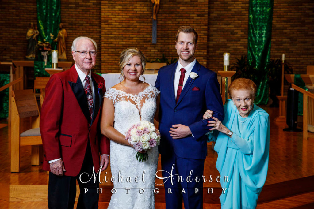 The bride and groom with her grandparents taken at the altar prior to their Saint Joseph of the Lakes wedding.