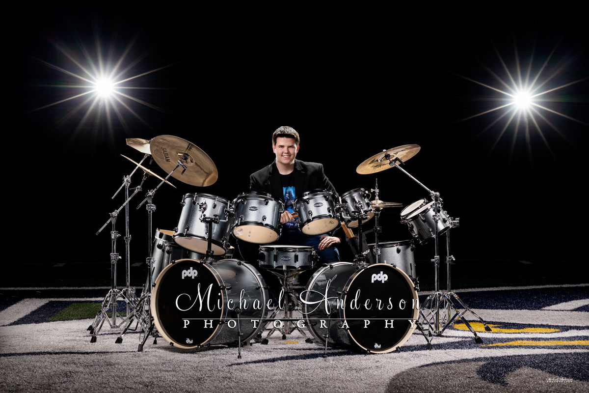A cool light painted senior photo of a boy and his drum set at Totino Grace High School in Fridley, MN.