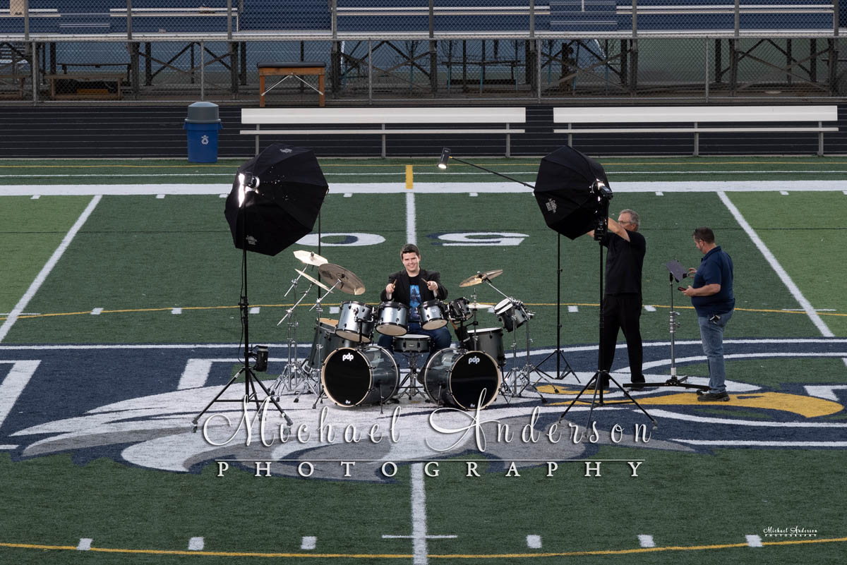 The setup image of a boy and his drum set for a light painting at his high school football field.