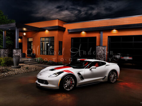 A stunning light painted photograph of a 2017 Corvette Grand Sport in front a beautiful contemporary home in the Ozarks.