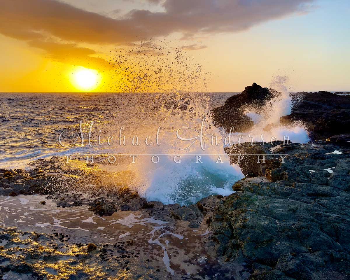 A pretty sunset, with a big wave splashing, captured with an iPhone at Pele's Well near Kona, Hawaii.