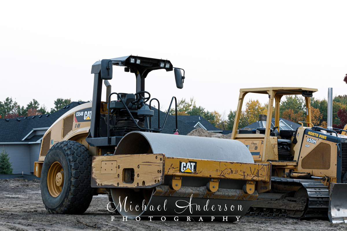 A photo of a Caterpillar CS54B Steamroller next to a bulldozer. This was the base image for a light painting of the steamroller.