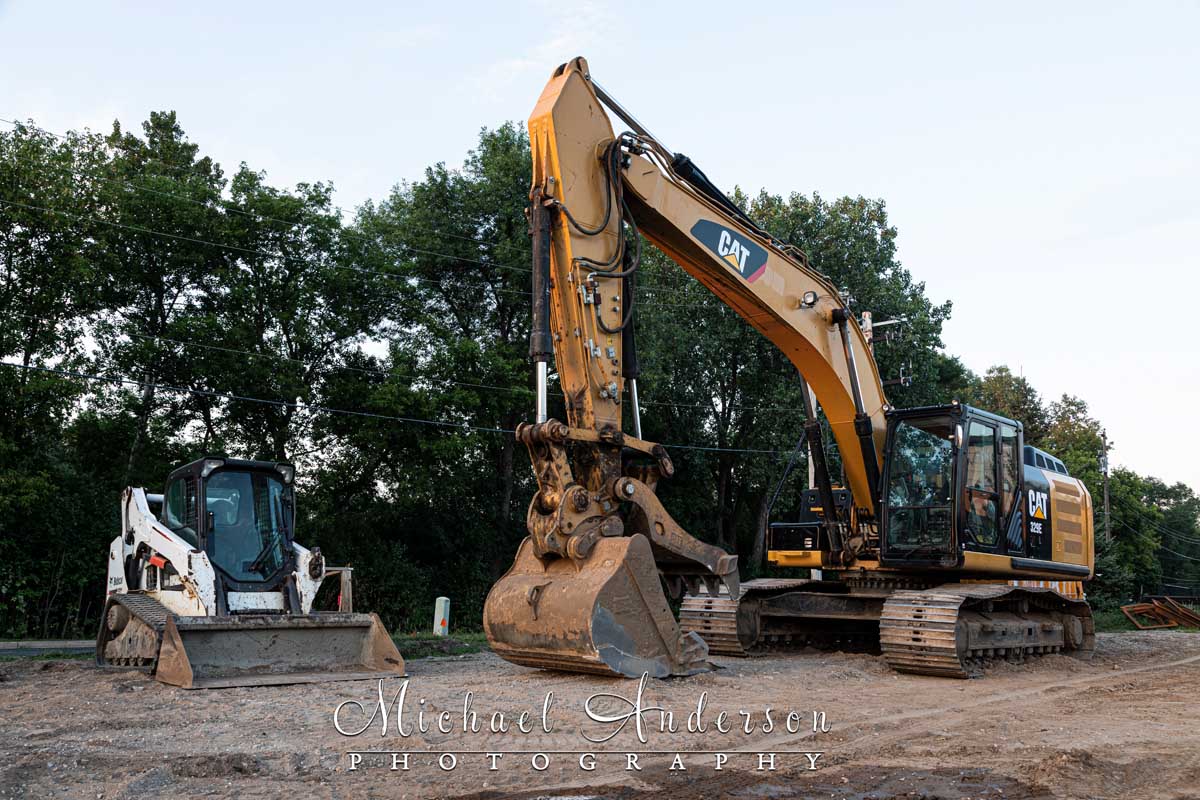 Photo of a of a CATERPILLAR 329 EL and a Bobcat T590 prior to light painting them.