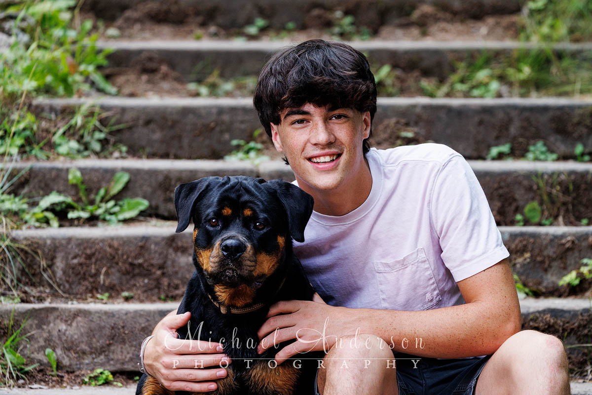 Senior photo of a boy and his dog at Lester Park in Duluth, MN.