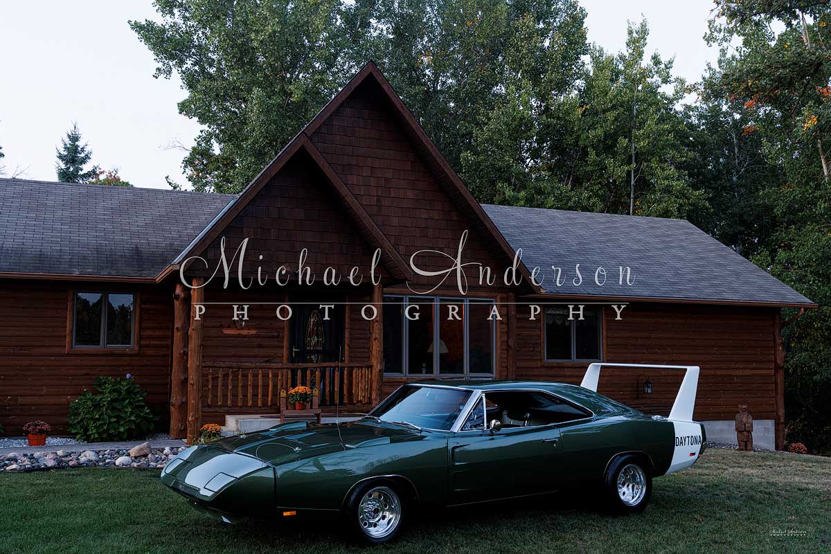 Photo of a rare 1969 Dodge Daytona and a beautiful log home just prior to light painting them both.