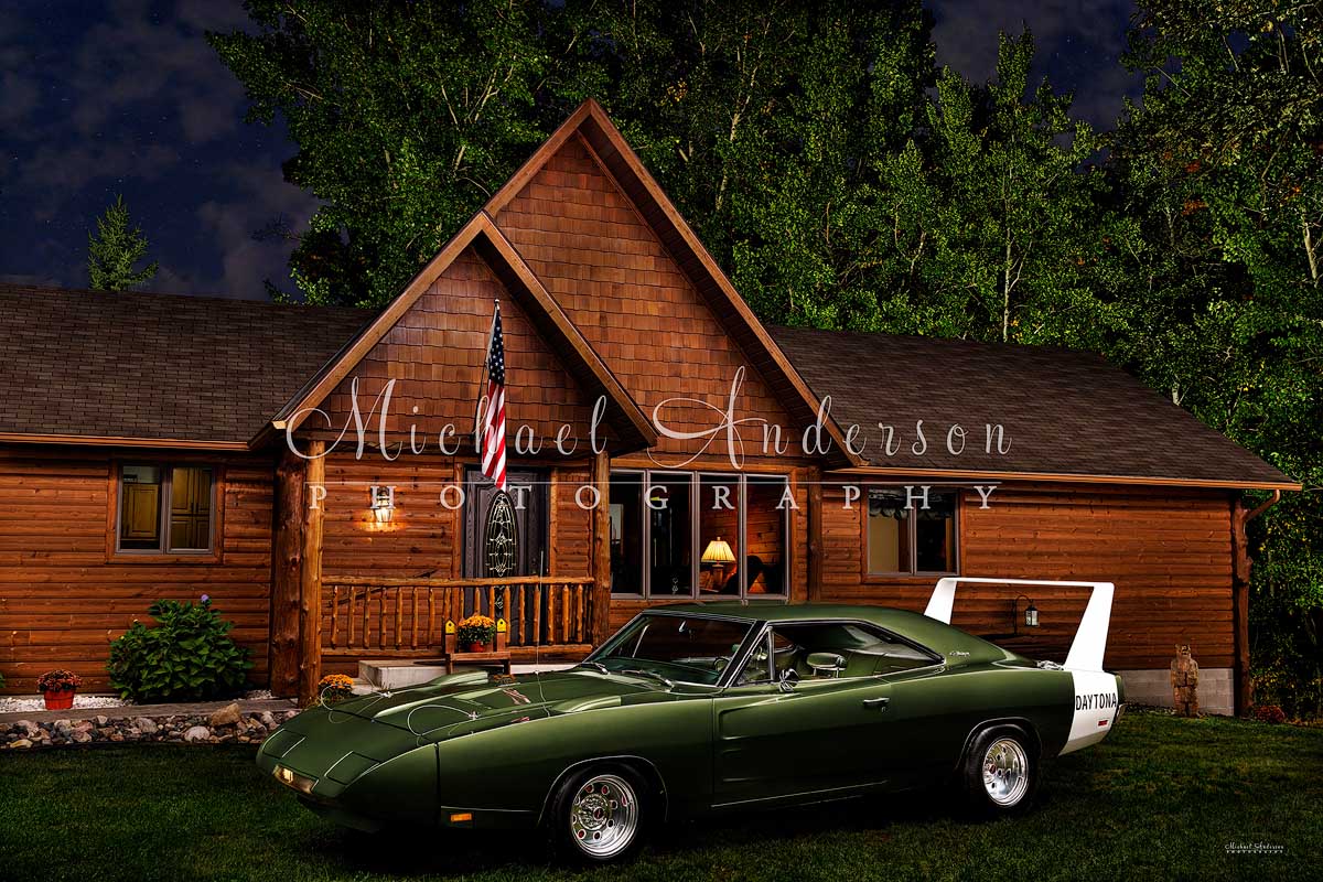 Light painted photo of a rare 1969 Dodge Daytona and a beautiful log home.