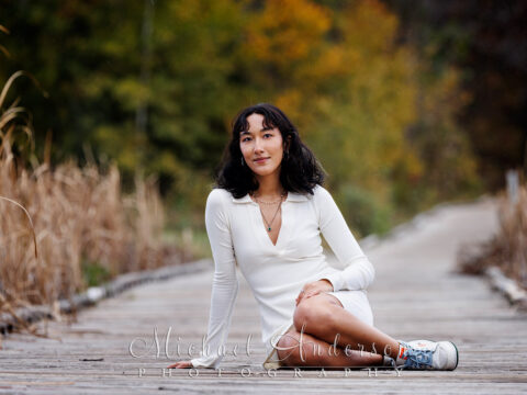 A beautiful fall color senior photo created on the boardwalk at Bunker Hills Regional Park in Andover, Minnesota.