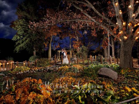 A pretty light painted wedding photograph of the bride and groom in beautiful fall colors at Brianno's Chart House in Lakeville, MN.