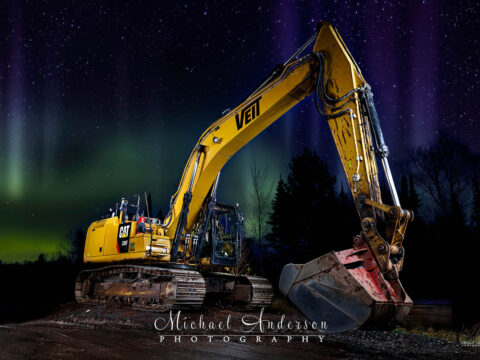 Light painted photograph of a Caterpillar 336F Excavator, under the Northern Lights, near Two Harbors on Lake Superior.
