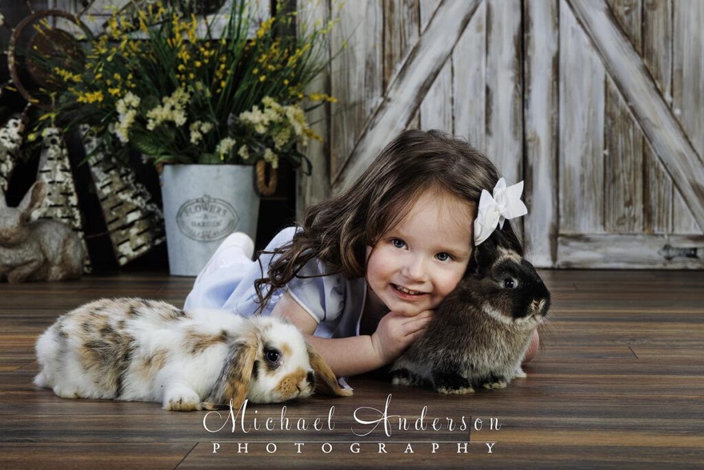 Adorable-Easter-photos-cute-three-year-old-girl-cuddles-with-two-bunnies