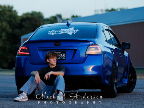 Senior photo of a boy with his 2017 Subaru WXR.