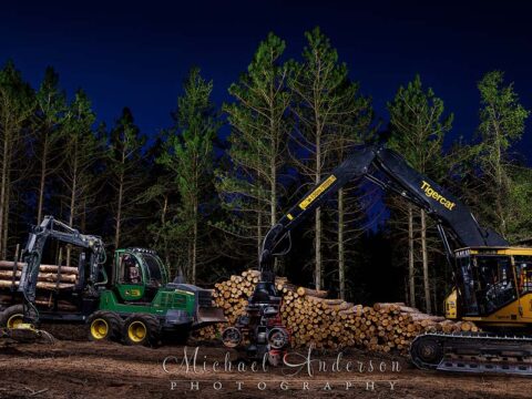 A cool light painted photo of a John Deere 1210 Forwarder and a Tigercat H822E Skidder with a Waratah HTH623C Harvester Head.