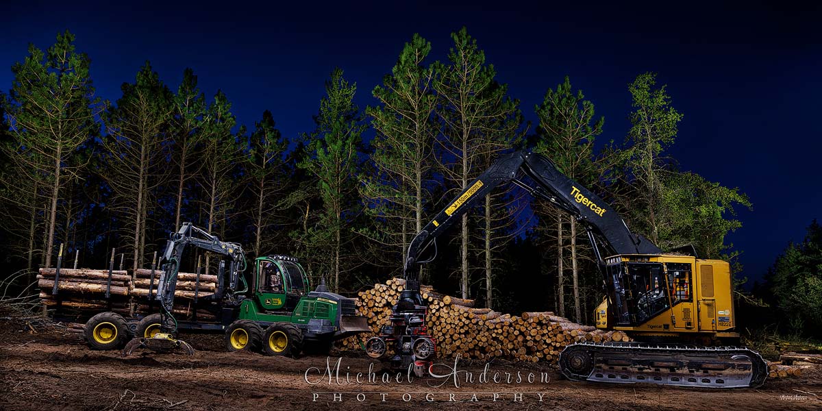 A cool light painted photo of forestry and logging equipment. There's a John Deere 1210 Forwarder and a Tigercat H822E Skidder with a Waratah HTH623C Harvester Head.
