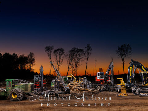 A cool light painted photograph of six pieces of heavy logging equipment owned and operated by Fornengo Forest Products in Danbury, Wisconsin.