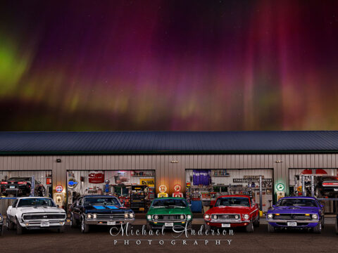 A pretty light painted photo of nine muscle cars in northern Minnesota.