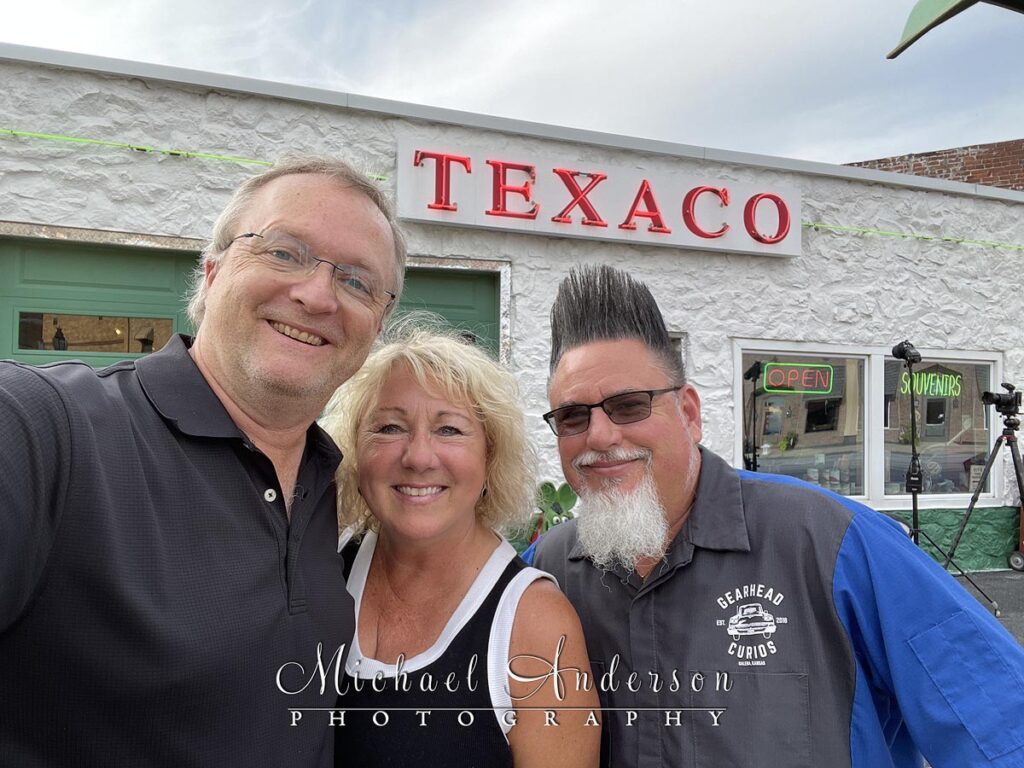 Professional photographers Michael and Joannie Anderson, with Aaron Perry, owner of Gearhead Curios. Photo was taken in front of his beautifully restored vintage Texaco Station on Route 66 in Galena, Kansas.