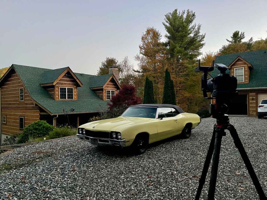 Set up photo of a 1972 Buick Skylark Convertible and a pretty cabin prior to light painting the entire scene.
