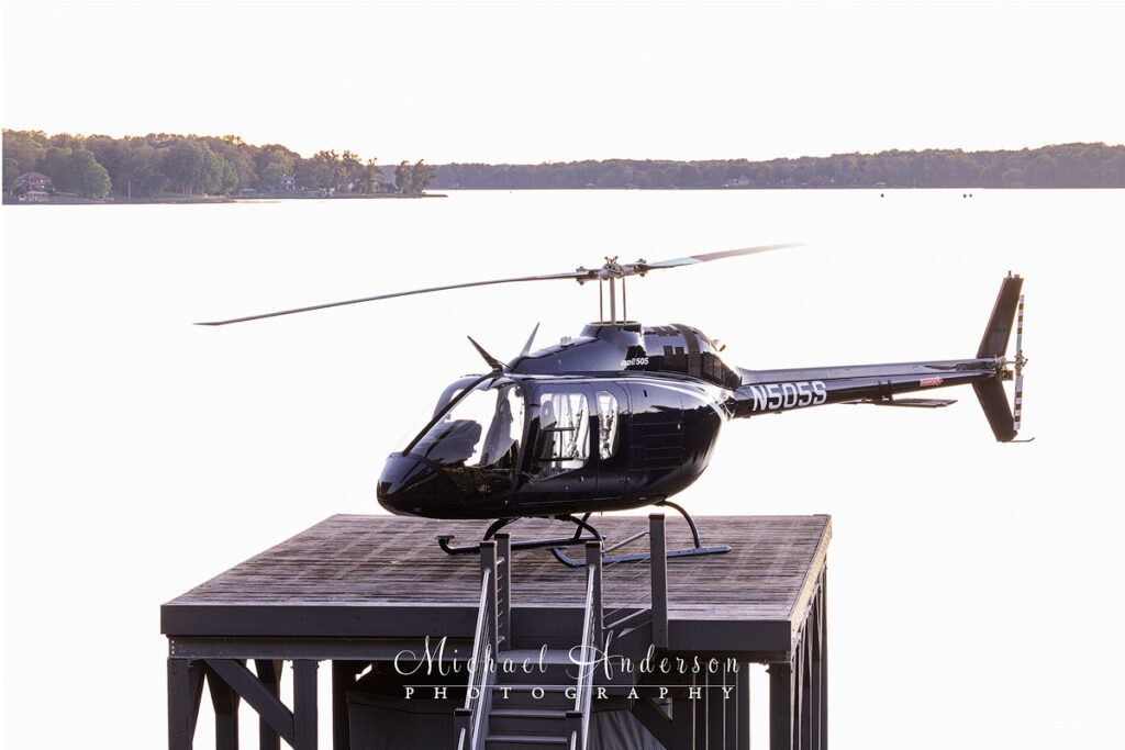 The pre-light painting set up photo of a Bell 505 Jet Ranger X Helicopter on a helipad over Lake Norman.