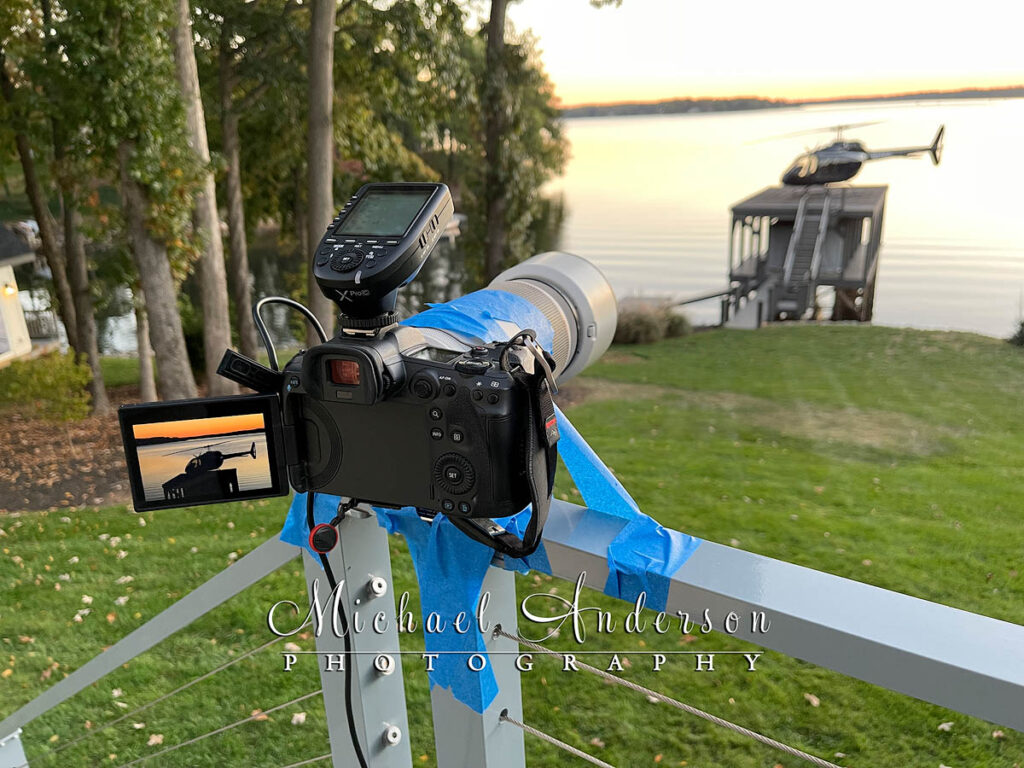 Light painting like MacGyver! The camera setup for a light painting project of a Bell 505 Jet Ranger X Helicopter using a deck railing and painters tape to hold the camera down.