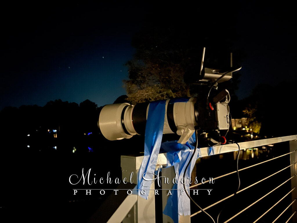 Light painting like MacGyver! The camera setup for a light painting project using a deck railing and painters tape to hold the camera down.