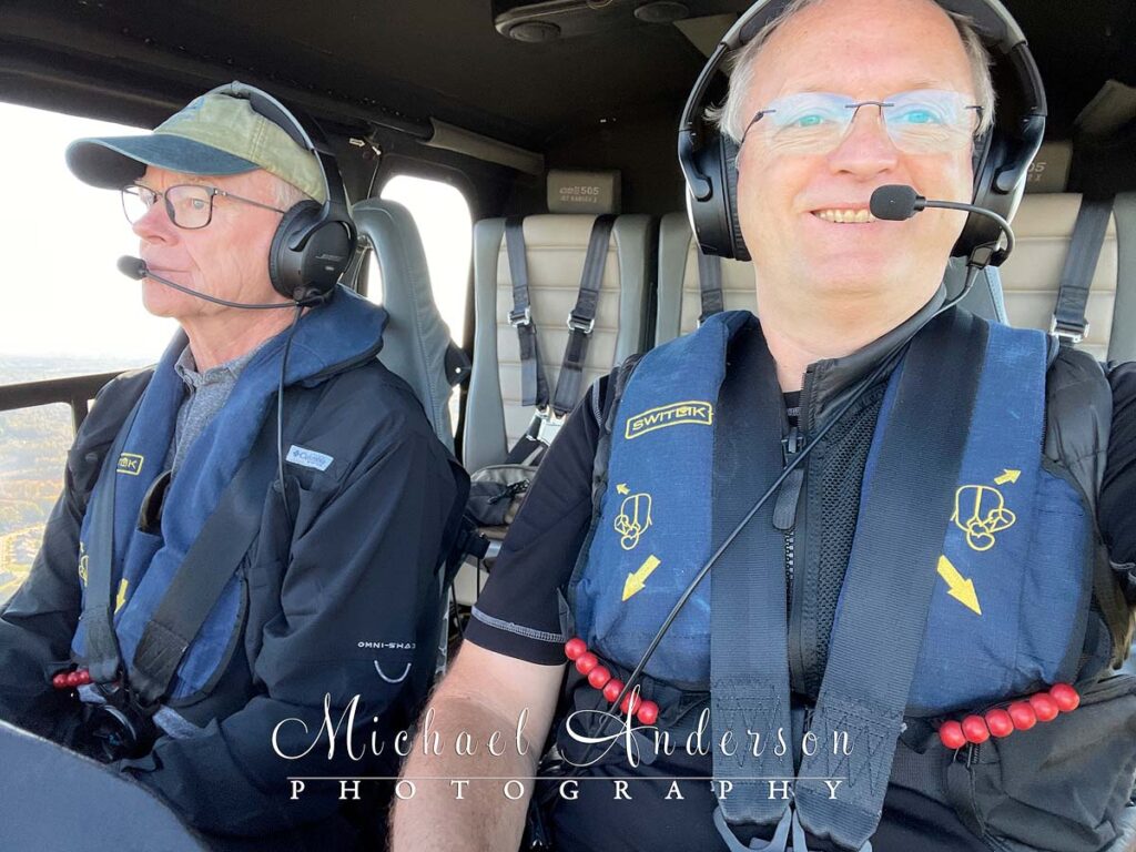 The pilot and passenger in a Bell 505 Helicopter cockpit.