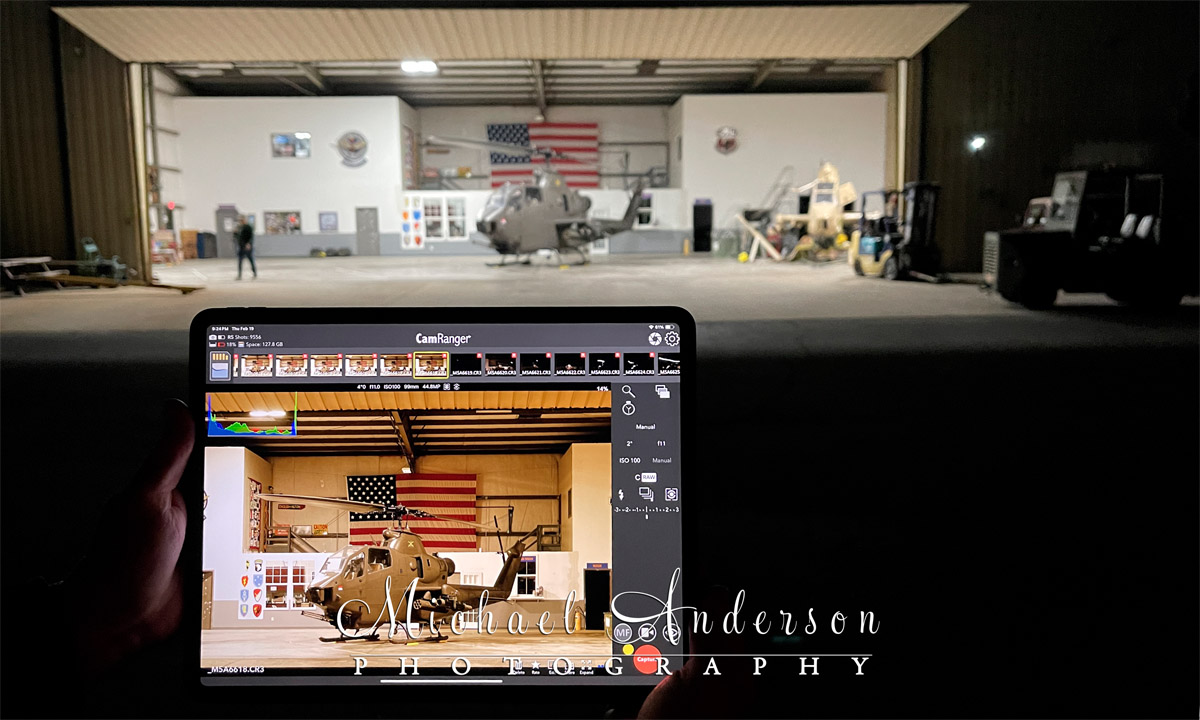 Behind-the-scenes photo of the light painting setup of AH-1F Cobra N826HF in the hangar at Army Aviation Heritage Foundation & Flying Museum in Hampton, GA. The image on the iPad Pro's screen is what the camera would be capturing that night.