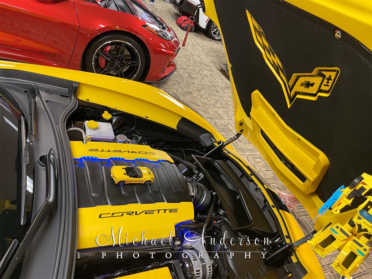 Under the hood of a cool yellow and black 2014 Corvette Stingray Convertible.