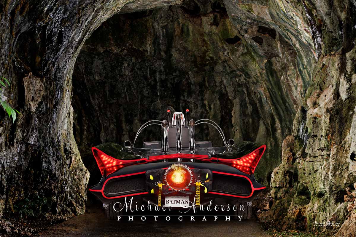 Cool light painted photograph of the Batmobile entering the Batcave.