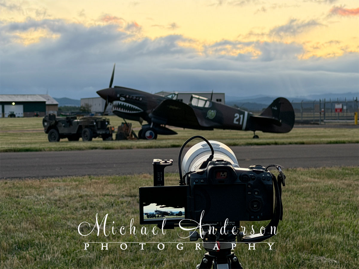 Behind the scenes photo of the setup to light-paint a restored P-40 and a WWI Willys Jeep.