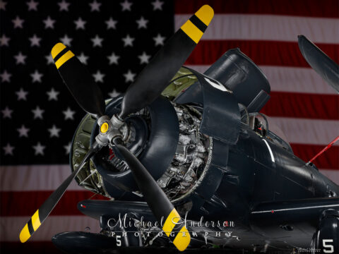 Light painted photograph of a 1952 AD-4N Skyraider with the American Flag behind it.