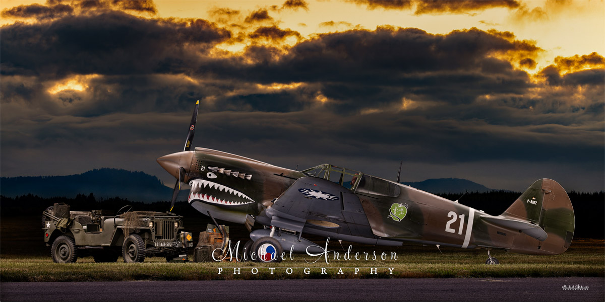 A stunning light painted photograph of a restored P-40 N-1 Kittyhawk and a WWII Willys Jeep.
